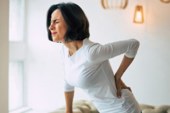 Chronic,Back,Pain.,Adult,Woman,Is,Holding,Her,Lower,Back,