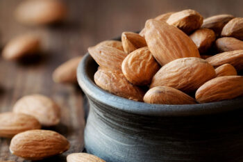 Almonds,In,A,Black,Bowl,Against,Dark,Rustic,Wooden,Background