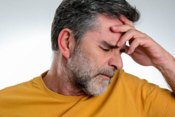 Mature,Man,Having,A,Headache,Isolated,Over,Grey,Background.,Picture